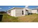 Exterior of home with easy access to a back door and a well maintained lawn at 643 Blackburn Blvd, North Port, FL 34287