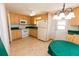 Cozy kitchen featuring wooden cabinets, white appliances, and a tile backsplash at 643 Blackburn Blvd, North Port, FL 34287
