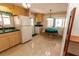 Kitchen with light wood cabinets, green countertops, and a bright eating nook at 643 Blackburn Blvd, North Port, FL 34287