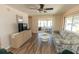 Bright living room with a ceiling fan, wood floors, and a view into the screened-in lanai at 643 Blackburn Blvd, North Port, FL 34287