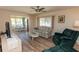 Cozy living area featuring a floral sofa, plush armchairs, and views of the lanai at 643 Blackburn Blvd, North Port, FL 34287