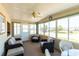 Bright sunroom with comfortable seating, ceiling fan, and lots of windows allowing for plenty of natural light at 643 Blackburn Blvd, North Port, FL 34287