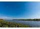 Calm waterfront view with lush vegetation, showcasing a serene and natural environment at 643 Blackburn Blvd, North Port, FL 34287