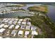 Aerial view of a well-maintained community near a lake with lush greenery at 713 Riverview Cir, North Port, FL 34287
