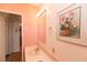 Cozy pink bathroom with a vanity, mirror, lighting fixture, and a painting at 713 Riverview Cir, North Port, FL 34287