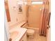 Simple bathroom includes a shower, toilet, and sink, providing a clean and functional space at 713 Riverview Cir, North Port, FL 34287