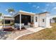 Exterior of a well-maintained home with a carport, screened-in lanai, and landscaping at 713 Riverview Cir, North Port, FL 34287