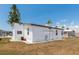 Exterior of a cozy white home with large windows and a neatly maintained yard at 713 Riverview Cir, North Port, FL 34287