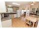 Open floorplan between kitchen, dining area and living room, with laminate floors throughout at 713 Riverview Cir, North Port, FL 34287