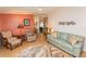 Inviting living room features bright walls, ceiling fan, and comfortable seating arrangement at 713 Riverview Cir, North Port, FL 34287
