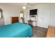 Bright main bedroom with closet and desk, offers functional comfort and ample storage at 713 Riverview Cir, North Port, FL 34287