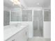 Bright bathroom with a glass enclosed shower and modern vanity with countertop at 8488 Saint Kitts Cir, Englewood, FL 34224
