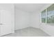 Bright bedroom with neutral tones and large window at 8488 Saint Kitts Cir, Englewood, FL 34224