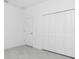 Bright bedroom with tile floors and a closet at 8488 Saint Kitts Cir, Englewood, FL 34224