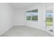 A bright room featuring a sliding glass door to the lanai at 8488 Saint Kitts Cir, Englewood, FL 34224