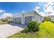 A modern home exterior with a two-car garage, landscaped yard and brick driveway for curb appeal at 8488 Saint Kitts Cir, Englewood, FL 34224
