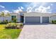Beautiful single-story home with a three-car garage and well-maintained landscaping at 8488 Saint Kitts Cir, Englewood, FL 34224