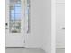 Bright foyer with tile flooring and glass front doors at 8488 Saint Kitts Cir, Englewood, FL 34224