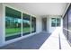 The screened-in lanai features a brick floor and glass sliding doors for versatile indoor-outdoor living at 8488 Saint Kitts Cir, Englewood, FL 34224