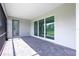 This covered brick lanai offers outdoor relaxation and access via glass sliding doors and an entry door at 8488 Saint Kitts Cir, Englewood, FL 34224