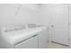 Functional laundry room with modern appliances, a utility sink, and ample storage space at 8488 Saint Kitts Cir, Englewood, FL 34224