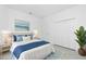 This main bedroom features a bed, nightstands and a tropical vibe at 8488 Saint Kitts Cir, Englewood, FL 34224