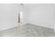 A clean, well-lit bedroom with a bathroom en suite and neutral tile flooring at 8652 Seasalt Loop, Englewood, FL 34224