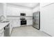 Modern kitchen featuring stainless steel appliances, white cabinetry, and light countertops at 8652 Seasalt Loop, Englewood, FL 34224