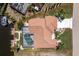 Aerial view of a beautiful home with a private pool, boat dock, and well-maintained landscaping at 910 Via Tripoli, Punta Gorda, FL 33950