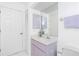 Clean bathroom featuring a large mirror, modern vanity, and white tile flooring at 910 Via Tripoli, Punta Gorda, FL 33950