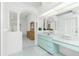 Bright bathroom featuring double sinks, vanity area, and decorative columns at 910 Via Tripoli, Punta Gorda, FL 33950