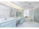 Bright bathroom features double sinks, a soaking tub, and a glass-enclosed shower at 910 Via Tripoli, Punta Gorda, FL 33950