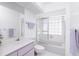 Well-lit bathroom featuring glass block window, modern fixtures, and updated vanity at 910 Via Tripoli, Punta Gorda, FL 33950