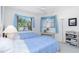 Light filled bedroom with twin beds, sheer curtains, and neutral carpet at 910 Via Tripoli, Punta Gorda, FL 33950