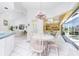 Eat-in kitchen dinette features a lovely pool view and natural light, opening to the living room at 910 Via Tripoli, Punta Gorda, FL 33950
