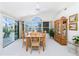 Bright dining room with backyard views, neutral decor, and a classic wooden table with seating for six at 910 Via Tripoli, Punta Gorda, FL 33950