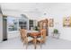 Bright dining room featuring a wooden table set, china cabinet, and large windows at 910 Via Tripoli, Punta Gorda, FL 33950