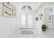 Bright foyer with double doors, tile flooring, columns, and stylish decor at 910 Via Tripoli, Punta Gorda, FL 33950