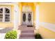 Charming front entrance with double doors, columns, and well-maintained landscaping at 910 Via Tripoli, Punta Gorda, FL 33950