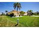 Well-maintained lawn and mature tropical landscaping at 910 Via Tripoli, Punta Gorda, FL 33950