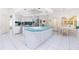 Bright kitchen with an adjacent dining area and access to the outdoors at 910 Via Tripoli, Punta Gorda, FL 33950