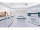 Open kitchen with tile countertops, tile floors and white cabinetry at 910 Via Tripoli, Punta Gorda, FL 33950