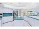 Bright kitchen featuring white cabinetry and tile countertops at 910 Via Tripoli, Punta Gorda, FL 33950