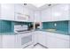 Modern kitchen with tile countertops, white cabinets and stainless steel appliances at 910 Via Tripoli, Punta Gorda, FL 33950