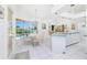 Bright kitchen and breakfast nook with white cabinetry and a view of the pool at 910 Via Tripoli, Punta Gorda, FL 33950