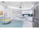 Bright kitchen featuring white cabinetry, stainless steel refrigerator and beautiful backsplash at 910 Via Tripoli, Punta Gorda, FL 33950