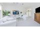 Bright and airy living room with white furniture, vaulted ceilings, and open layout at 910 Via Tripoli, Punta Gorda, FL 33950