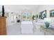 Bright living room features neutral décor, vaulted ceilings, and plenty of natural light from the large front window at 910 Via Tripoli, Punta Gorda, FL 33950