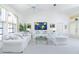 Bright living room with white couches, vaulted ceiling, and a large window with natural light at 910 Via Tripoli, Punta Gorda, FL 33950