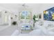 Bright living room features neutral décor, vaulted ceilings, and plenty of natural light from the large front window at 910 Via Tripoli, Punta Gorda, FL 33950